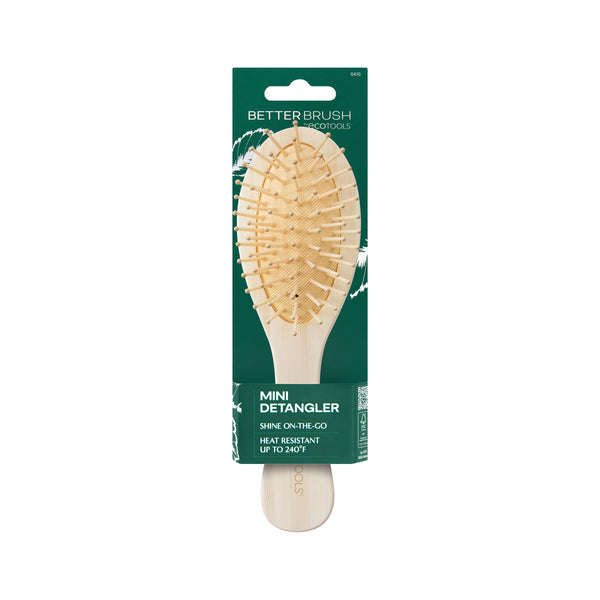Mini detangler hair brush in blister pack with green product card