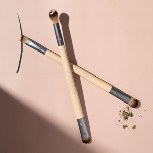 Two eye makeup brushes with beige handles and dark bristle tips for smudging and blending