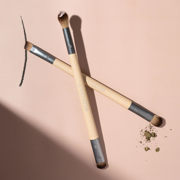 Two eye makeup brushes with beige handles and dark bristle tips for smudging and blending