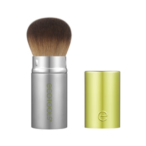 Retractable face brush with silver handle, brown bristles, and lime cap