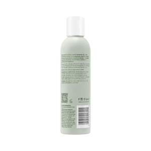 Makeup brush + sponge shampoo bottle with light green liquid, white cap, back label