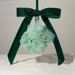 Delicate pouf: mint green mesh bath scrub ball with dark green ribbon and label tag