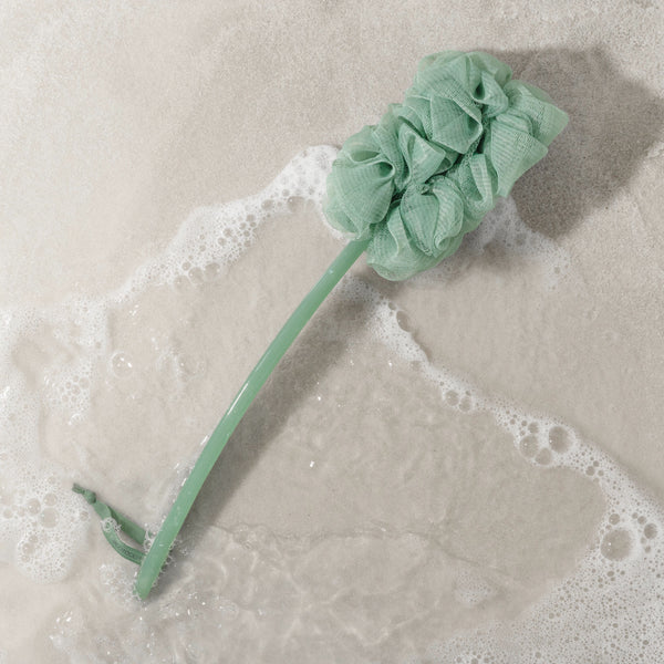 Light green bath pouf brush with ruffled sponge head and handle
