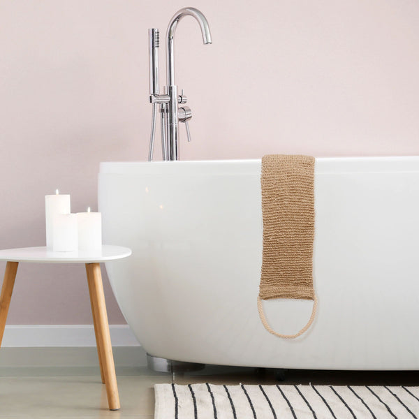 Exfoliating back scrubber hanging over a bath tub edge