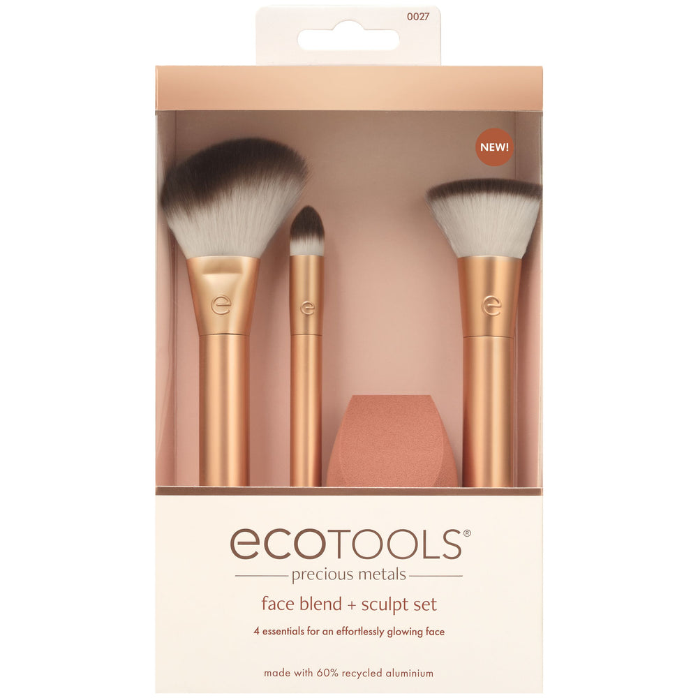 Makeup brush set with three gold brushes and a teardrop blending sponge.
