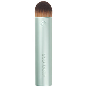 Domed blending makeup brush with dense brown bristles on a light mint tube handle