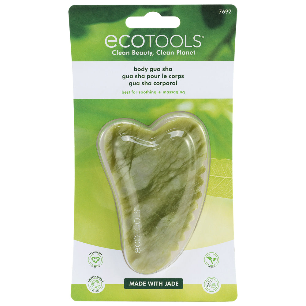Green jade gua sha stone with wavy shape and scalloped edge