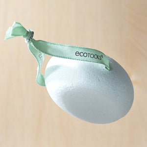 Hanging oval white pumice stone with green loop strap for foot exfoliation