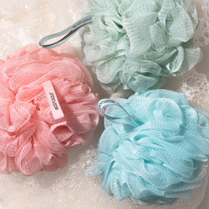 Green recycled mesh bath pouf with hanging loop and soft rosette shape