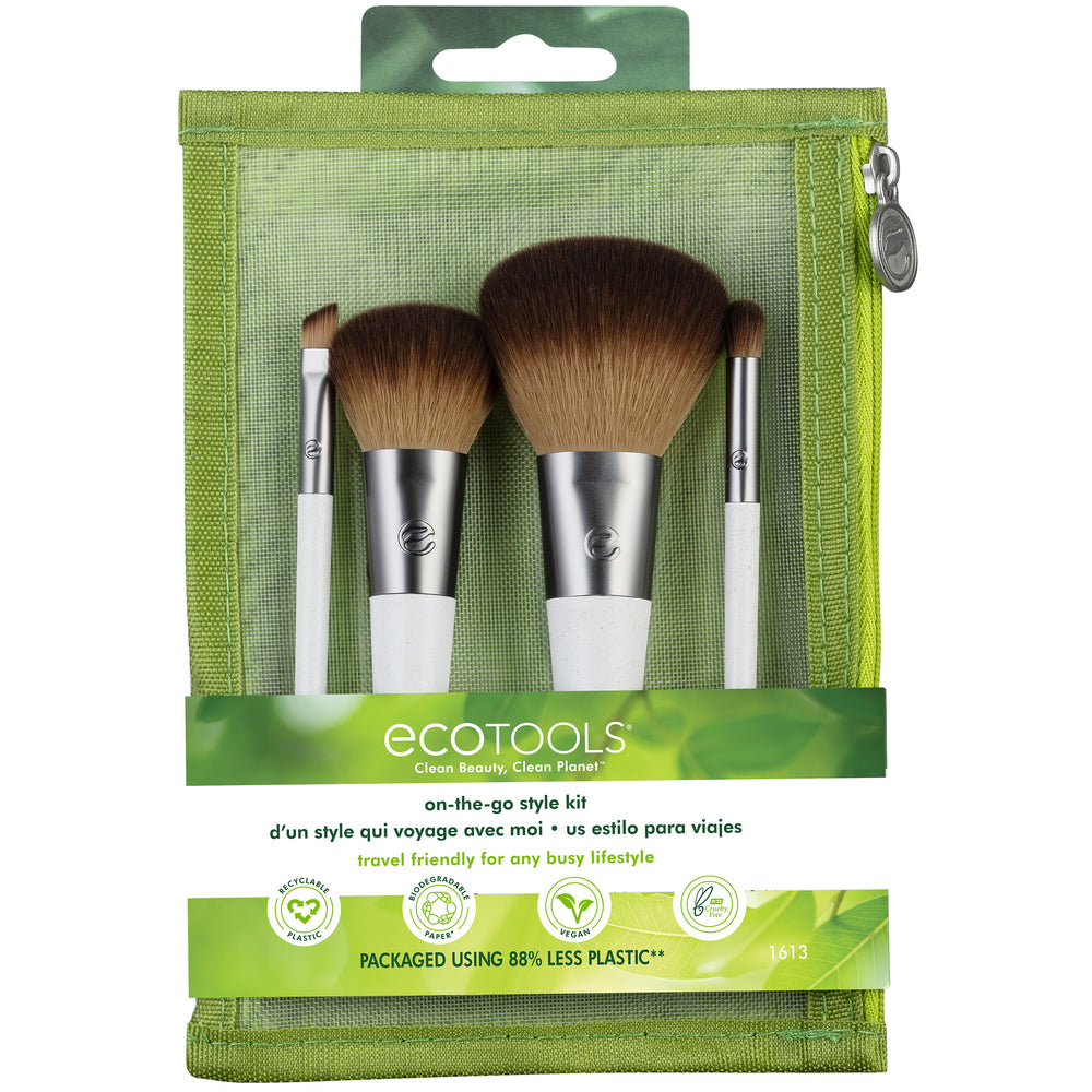 Makeup brush set with 4 brushes, brown bristles, white handles, dark ferrules.