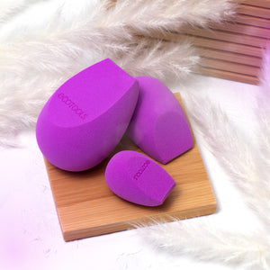 Purple Bioblender makeup sponges set of three with teardrop shapes on wooden board