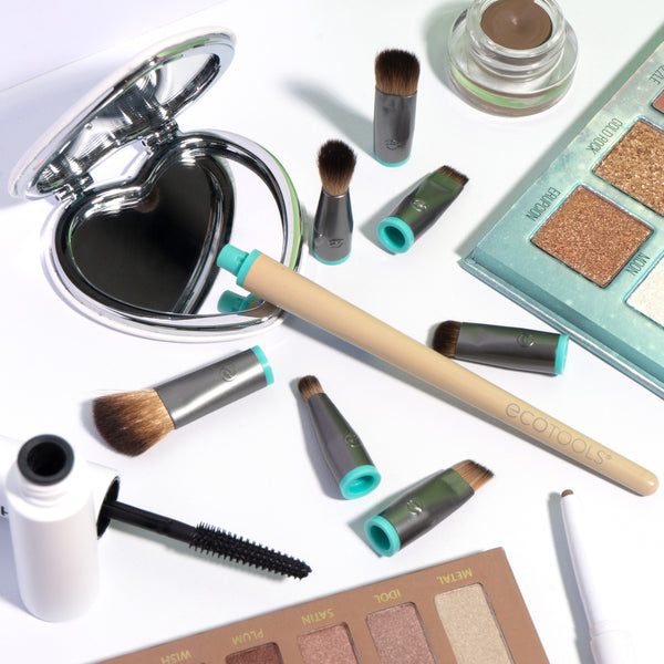 Assorted eye makeup brushes with beige handles and teal ferrules, ready to use