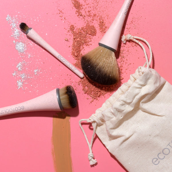 Compact makeup brushes with beige handles and brown bristles, with beige hemp storage pouch