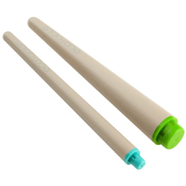Beige interchangeable makeup brush handles with green and teal end caps, angled view