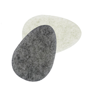 Two infused facial sponges, light beige and dark gray overlapping teardrop pads