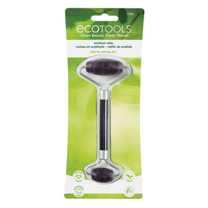 Amethyst facial roller in green retail package with two purple roller stones