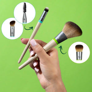 Face makeup brush set held in hand, includes fluffy foundation brush and spoolie