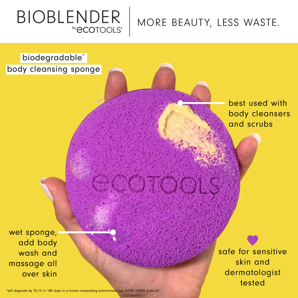 Purple round body cleansing sponge with loop, held in hands