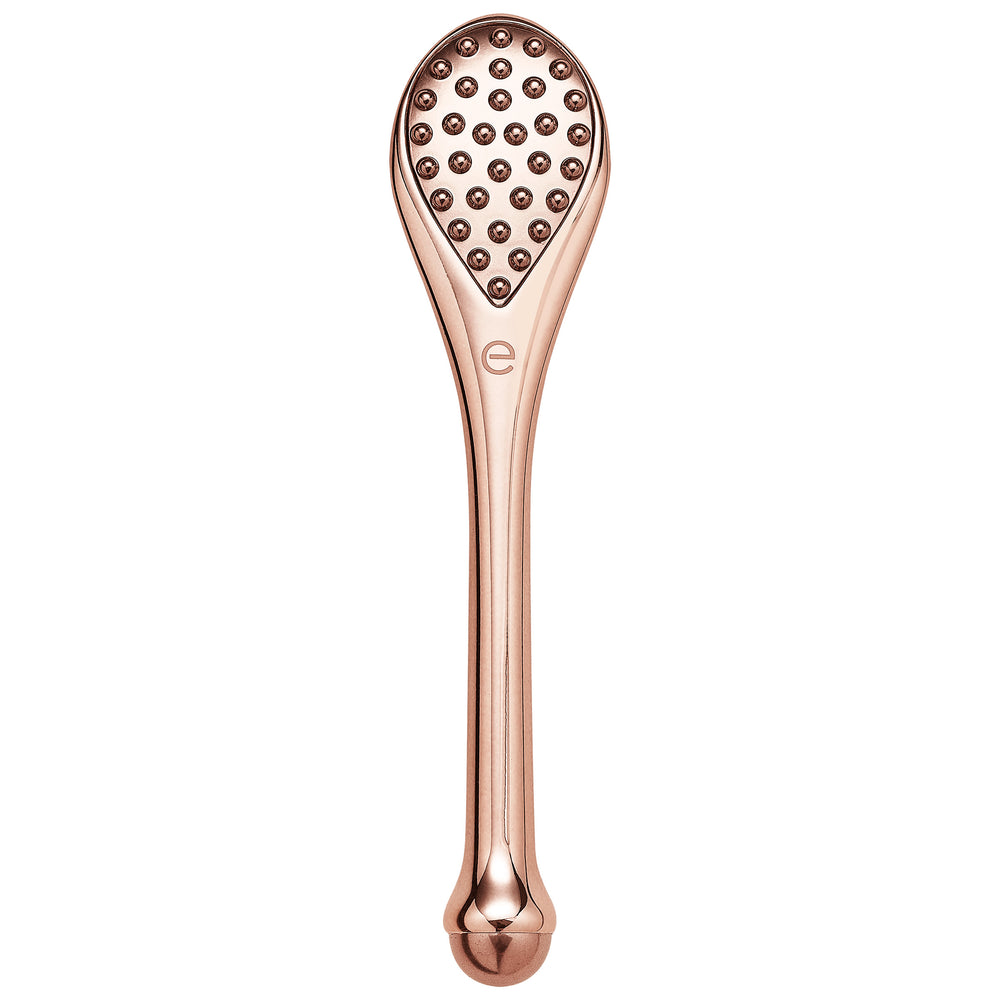 Rose-gold handheld massage tool with textured knob head